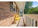 Cozy front porch with a seating area and a beautiful brick facade at 1207 Grant St, Durham, NC 27701
