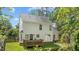 Lush backyard with a well-maintained lawn and a wooden deck attached to the house at 12117 Inglehurst Dr, Raleigh, NC 27613