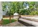 Backyard wooden deck featuring a comfortable outdoor sofa and a view of the fenced yard at 12117 Inglehurst Dr, Raleigh, NC 27613