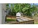 Backyard wooden deck featuring a comfortable outdoor sofa and a view of the fenced yard at 12117 Inglehurst Dr, Raleigh, NC 27613