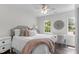 Inviting bedroom featuring a comfortable bed, soft textures, and natural light from the window at 12117 Inglehurst Dr, Raleigh, NC 27613