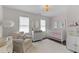 Charming Bedroom with soft colors, a crib, and a cozy armchair, creating a peaceful atmosphere at 12117 Inglehurst Dr, Raleigh, NC 27613
