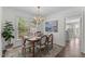 Traditional dining room with a wood table, upholstered chairs, and a large window for natural light at 12117 Inglehurst Dr, Raleigh, NC 27613