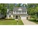 Charming two-story home with a well-manicured lawn, a welcoming front porch, and a two-car garage at 12117 Inglehurst Dr, Raleigh, NC 27613