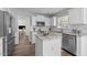 Bright kitchen featuring white cabinetry, stainless steel appliances, and a center island with stone countertop at 12117 Inglehurst Dr, Raleigh, NC 27613