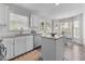Modern kitchen featuring white cabinetry, stainless steel appliances, and an eat-in breakfast nook at 12117 Inglehurst Dr, Raleigh, NC 27613