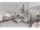 Spacious living room with high ceilings, staircase, and stylish decor at 12117 Inglehurst Dr, Raleigh, NC 27613
