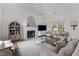 Comfortable living room with fireplace, hardwood floors, and natural lighting at 12117 Inglehurst Dr, Raleigh, NC 27613