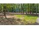 Community playground surrounded by lush trees and greenery for outdoor fun at 12117 Inglehurst Dr, Raleigh, NC 27613