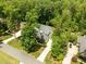 An inviting home with lush greenery, long driveway, and gray roof in a tranquil neighborhood at 12216 Kyle Abbey Ln, Raleigh, NC 27613