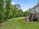 Expansive backyard featuring a well-maintained lawn, a fire pit, and mature trees for added privacy at 12216 Kyle Abbey Ln, Raleigh, NC 27613