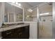 Bright bathroom featuring a glass shower, granite counters, and dark wood cabinets at 12216 Kyle Abbey Ln, Raleigh, NC 27613