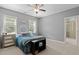 Spacious bedroom with natural light and neutral walls next to an ensuite bathroom at 12216 Kyle Abbey Ln, Raleigh, NC 27613