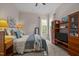 Cozy bedroom featuring neutral walls, carpet flooring, a window, and wood shelving with TV at 12216 Kyle Abbey Ln, Raleigh, NC 27613