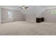 Spacious bonus room features neutral colored walls and carpet, window and wet bar at 12216 Kyle Abbey Ln, Raleigh, NC 27613
