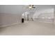 Spacious bonus room with neutral carpet and ceiling fan, perfect for a playroom or media center at 12216 Kyle Abbey Ln, Raleigh, NC 27613