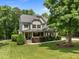 Beautiful two-story home with lush landscaping, a well-maintained lawn and classic architectural details at 12216 Kyle Abbey Ln, Raleigh, NC 27613