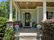 Inviting front porch with stone pillars, tasteful decor, and stylish planters, creating a welcoming entrance at 12216 Kyle Abbey Ln, Raleigh, NC 27613