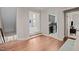 Hallway with wood floors and three open doorways leading to a laundry, and two separate living spaces at 12216 Kyle Abbey Ln, Raleigh, NC 27613