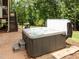 Relaxing backyard hot tub with steps, perfect for unwinding, with an outdoor grill and fire pit nearby at 12216 Kyle Abbey Ln, Raleigh, NC 27613