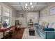 Bright living room featuring coffered ceilings, hardwood floors, a desk, and an abundance of natural light at 12216 Kyle Abbey Ln, Raleigh, NC 27613