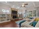 Inviting living room with a stone fireplace, built-in shelves, hardwood floors, and ample natural light at 12216 Kyle Abbey Ln, Raleigh, NC 27613