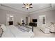 Spacious main bedroom featuring tray ceilings, carpet flooring, seating, and access to ensuite bathrooms at 12216 Kyle Abbey Ln, Raleigh, NC 27613