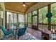 Enjoy outdoor living on the screened porch with dining area and comfortable seating at 12216 Kyle Abbey Ln, Raleigh, NC 27613