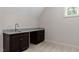 Wet bar featuring granite countertops and stylish dark wood cabinets, perfect for entertaining at 12216 Kyle Abbey Ln, Raleigh, NC 27613