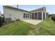 View of back of house with light blue siding, black fence, and screened-in patio at 123 Turnstone Dr, Durham, NC 27703