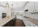 Modern kitchen with white cabinetry, stainless steel appliances, and a kitchen island at 123 Turnstone Dr, Durham, NC 27703