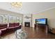 Spacious living room boasts a cozy fireplace, hardwood flooring, and large windows for natural light at 123 Turnstone Dr, Durham, NC 27703