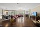 Open living room features hardwood floors, fireplace and a comfortable burgundy leather sectional sofa at 123 Turnstone Dr, Durham, NC 27703