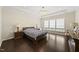 Serene main bedroom with hardwood floors, a tray ceiling and bright windows at 123 Turnstone Dr, Durham, NC 27703