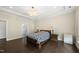 Elegant main bedroom features hardwood floors, a chandelier, and view into the bathroom at 123 Turnstone Dr, Durham, NC 27703