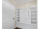 Mudroom features built-in shelving and hooks for organized storage by the exterior door at 123 Turnstone Dr, Durham, NC 27703