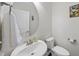 Compact powder room featuring a vessel sink, round mirror, and butterfly wall art at 123 Turnstone Dr, Durham, NC 27703