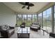 Relaxing sunroom with tile flooring, ceiling fan, and view of the fenced backyard at 123 Turnstone Dr, Durham, NC 27703