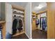 A spacious walk-in closet offers organized storage with shelves and hanging rods with wood trim at 123 Turnstone Dr, Durham, NC 27703