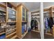 Custom walk-in closet featuring abundant built-in wood shelving and hanging storage for organization at 123 Turnstone Dr, Durham, NC 27703