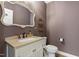 Powder room with marble sink, decorative mirror, and ornate shelving unit at 124 Lord Ashley Rd, Raleigh, NC 27610