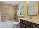 Bathroom with tiled shower and tub, framed mirror, and modern vanity at 124 Lord Ashley Rd, Raleigh, NC 27610