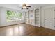 Bright bedroom with hardwood floors, ceiling fan and custom built in shelving at 124 Lord Ashley Rd, Raleigh, NC 27610