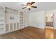 Bedroom featuring hardwood floors, ceiling fan and custom built in shelving at 124 Lord Ashley Rd, Raleigh, NC 27610