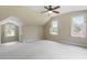 Spacious carpeted bedroom featuring natural light from multiple windows and a ceiling fan at 124 Lord Ashley Rd, Raleigh, NC 27610