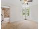 Bedroom with large windows and an en suite bathroom featuring tiled shower at 124 Lord Ashley Rd, Raleigh, NC 27610