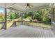 Spacious, covered deck with a ceiling fan and views of a large backyard at 124 Lord Ashley Rd, Raleigh, NC 27610