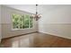 Elegant dining room with large window, chandelier, and wainscoting at 124 Lord Ashley Rd, Raleigh, NC 27610