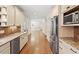 Modern kitchen with stainless steel appliances, granite countertops, and hardwood floors at 124 Lord Ashley Rd, Raleigh, NC 27610