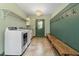 Spacious laundry room with ample storage, tile floors, and included washer/dryer at 124 Lord Ashley Rd, Raleigh, NC 27610